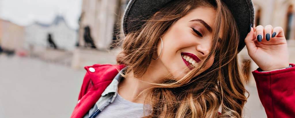 a woman smiles after getting enamel shaping