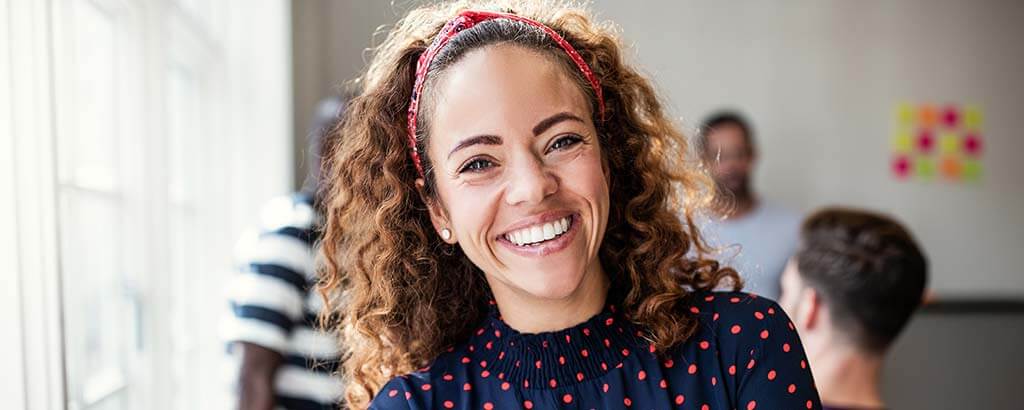 a woman smiles after getting a gum grafting