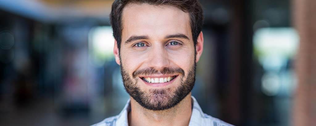 a young man gets post and core treatment and then smiles