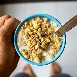 a person eats cereal and thinks about smile friendly breakfast secrets