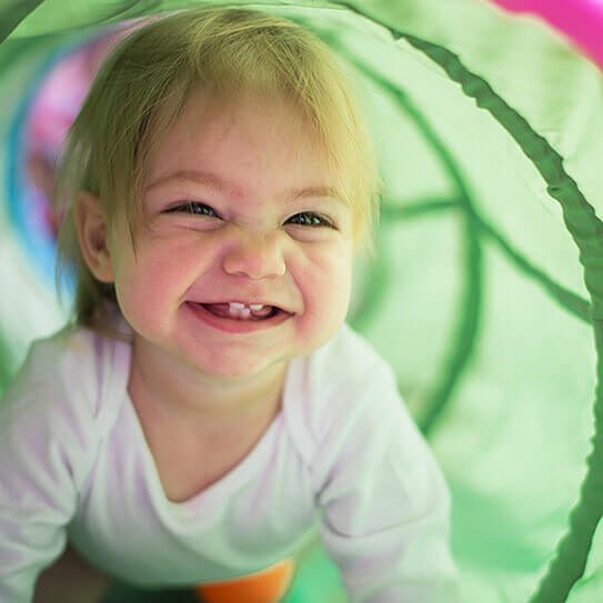 a baby crawls through a tunnel and makes its parents think about busted baby tooth myths