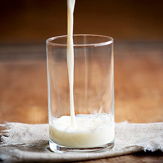 a glass of milk reminds people that calcium benefits your smile