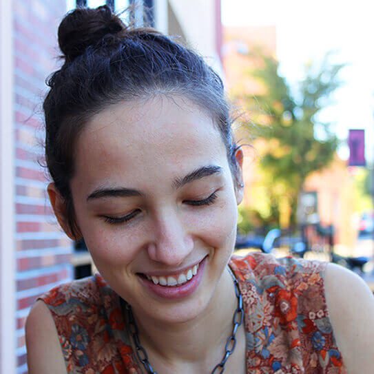 a woman smile as she remembers how to keep teeth clean between meals