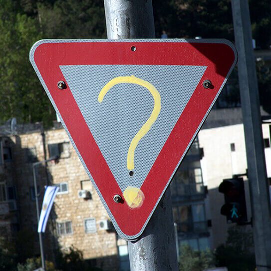 question mark on a yield sign reminds people of dental faqs