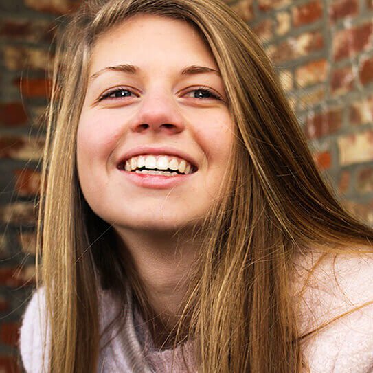 a teen girl listens to her friends talk about what to expect at your next dental checkups