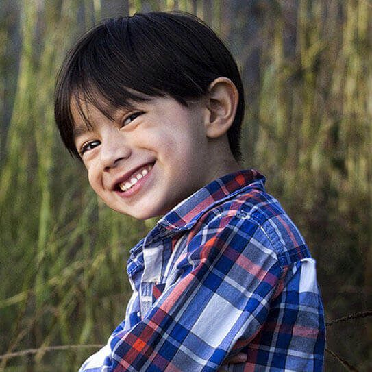 a little boy wonders about dental care for baby teeth